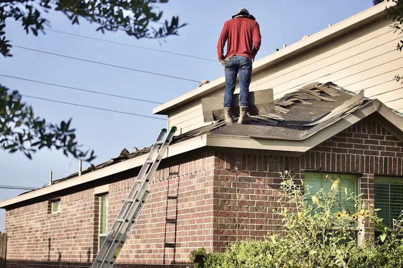 Professional roofer working on a residential roof in Lemoore
